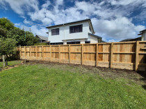 Timber fence on top of Retaining wall