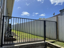 Steel fence and gate prevent the dog from escaping