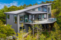 Ridge Road, Paremoremo - Cain Built Ltd. - A great example of the high quality builds Cain Built Ltd can achieve is shown in this stunning house nestled amongst the native bush of Paremoremo.

Set on a challenging block of land, both steep and surrounded by bush, this house makes a lasting impression. The most frequently made comment about this house and Cain Built’s ability is “If you can make this, you can make anything!”. It really reflects the type of work Cain Built Ltd can achieve with new builds or renovations.

This 180 sqm three storey family home is clad in a combination of cedar and linear weatherboard. There is plenty of light with 33 double glazed aluminium windows and doors.

Solid oak flooring from the open plan kitchen, dining and living area flows into the halls and stairwell, which consists of an open tread staircase that leads up to the master bedroom and down to the main entrance.

Each floor of this three storey new build has its own full bathroom with either oak or polished concrete floors and fully tiled walls.

From the living area there is a 70 sqm+ Kwila deck that sits among the tree tops with commanding views of the North Shore, Auckland City, Rangitoto, the Hunua ranges and if you’re lucky you can also see glimpses of Whenuapai airbase.