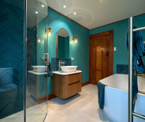 Bathroom Upgrade: Function Meets Elegance by Cleanline Bathrooms. - This space now boasts a corner shower, subway tiles, a recessed shelf, and a frameless glass door system for a clean, modern feel. The brushed brass tapware and twin rail shower add a hint of luxury.