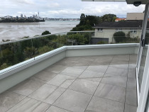 After - Complete project carried out by Complete Waterproofing and Building maintenance Ltd - We removed the old tiles, screed, membrane and timber joinery, replaced timber substrate, installed new membrane, aluminium joinery, installed glass balustrade and new floating tile system on Nurajacks. What a difference!