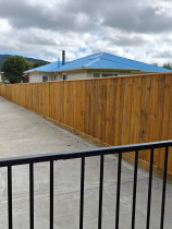 Fencing, concrete, pebbles, fence stain and topsoil and seeded