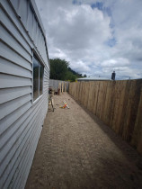 Fencing, concrete, pebbles, fence stain and topsoil and seeded