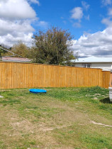 Fencing, concrete, pebbles, fence stain and topsoil and seeded