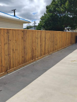 Fencing, concrete, pebbles, fence stain and topsoil and seeded