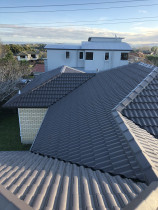 Concrete tile roof after restoration by Roof Restore - Restoration consisted of full roof wash and mold treatment, replacement of cracked tiles, Ridge and hip repoint and 4 coat reseal system.