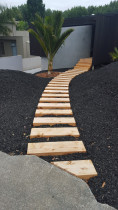 Floating Walkway by Lakeside Landscapes - Created this lovely new entrance way out of macrocarpa sleepers in Auckland's eastern bays. Finished off with contrasting black bark and some planting still to come.