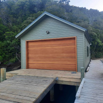 Boat shed - This was a job we were very proud of our finishing touches on the box corners and scribers were as good as you get. The stained cedar garage door turned out beautifully and is a really feature to this shed.