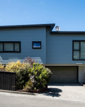 Elevated Transformation: From Flat to Feature - This home underwent a significant architectural uplift, starting with the removal of the original flat roof and the construction of a new, pitched design.
The entire exterior was revitalised with new cladding in a contemporary grey hue, providing a fresh and modern aesthetic.
Sleek, dark-framed window joinery replaced the existing, enhancing both the style and energy efficiency of the home.
The raised roofline introduces greater volume and a more dynamic silhouette to the property.
The new cladding provides improved weather protection and a low-maintenance finish for years to come.
This comprehensive renovation demonstrates our expertise in structural alterations and complete exterior makeovers.