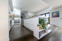 Kitchen Renovation by Moda Kitchens in Western Springs - Lovely bookcase spilling down the stairs finishes off the island in a stunning way.