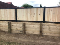 RETAINING AND FENCING - Laminata fencing with steel frame on top timber retaining wall