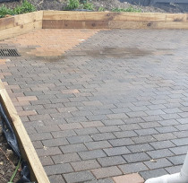 Paved area - New paved area reusing old brick pavers and new small timber retainers.