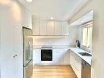 Back lit LED kitchen - This modern kitchen, with back lit LED lights really brings this kitchen to life! Our client opted for sleek white cabinetry with gold handles and wooden under panels.