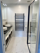 Ensuite Bathroom - Full remodel and design, removing a wall and inserting a cavity slider door to create a larger space. The client requested a custom made vanity with stunning stone top and whicker baskets.