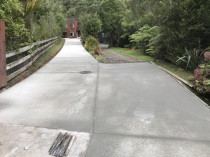 Titirangi concrete driveway after - Certainly looks better and no doubt drives better. 
before and after photo tell the story
new 5inch thick concrete driveway broom finish from subgrade ltd