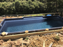 Pool Decking by Top 2 Bottom Carpentry Ltd - This was a great job that we started in Orewa, we excavated the area into the slope, drilled holes and fitted piles, and installed a huge fantastic Deck around the pool with steps leading back up to the house. (Part 1)