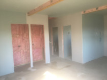 Basement Conversion (Part 4) - This image shows the walls and ceilings all lined with gib and plastered, ready for the doors to be installed.