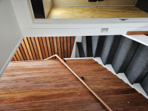 Rimu internal staircase - Topcat builders stripped down the old rimu weatherboards off the existing house and used them as a feature in this new build.