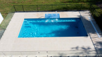 Coatesville Pool - This 9m pool was installed on a lifestyle property. Virtuoso Landscapes completed the tiling, fencing, pool pump shed, water feature/splash deck, as well as all the remedial works to the surrounding lawn area.