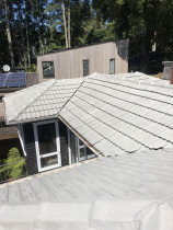 Concrete tile recoat by Roof Restore - This concrete tile had become very porous, after a thorough wash and our 3 coat reseal system the roof is ready for the winter rain.