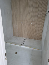 Bathroom - Floor and walls tiled 600mm×600mm porcelain tile with 1200mm feature tile