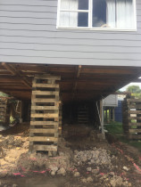 Basement conversion (Part 2) - Top 2 Bottom Carpentry Ltd had the Asbestos cladding professionally removed and disposed of, we then supported the house and removed all piles and bearers.
We excavated to dig into the sloping ground, and to form foundation trenches.