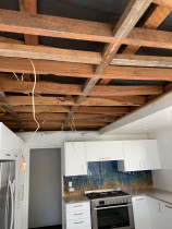 Kitchen Ceiling - Top 2 Bottom Carpentry Ltd professionally had the existing kitchen Asbestos ceiling removed, and discovered the ceiling joists were all out of line and warped, so we straightened the entire ceiling and re-lined it with insulation and Gib.