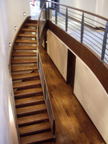 AMW Builders Ltd - Mt Laurel project Walnut stair and custom black Iron forged balustrade