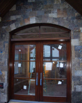 AMW Builders Ltd - Laurel Job - Mahogany entrance double door with baldwin hardware, Stone masonry custom blend of 125mm