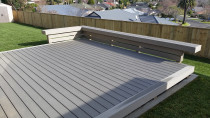 Permadeck composite deck with seating area completed by DECKHQ