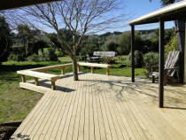 Pine deck with seating area by DECKHQ