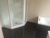 Handy Home Solutions - Separate shower and bath with dark floor tiles and cream wall tiles