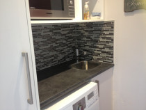 Mosaics around laundry tub by Just Splashbacks - Female Tiler