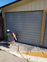 Repainting old garage doors to modernise exterior