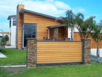 Omaha House by RD Construction Ltd - The extension on this property was completed in November/December 2008.  This is a coastal property.  
Features of this project were
a purpose built fish filleting stainless bench with inbuilt waste master at the back of the property.
a cavity for the flat screen tv inside
New inbuilt fireplace and chimney.
Stonework was in block modular form for fence and entry pilars and fireplace we installed the stonework
The fence was also comprised of a latest design double sided cedar weatherboard, this complemented the house and enhanced the property