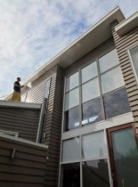 Soft Washing by Wash - Waterblasting Specialists - Rinsing off a weatherboard home